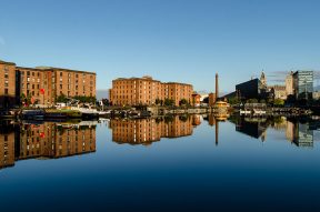 Vintage warehouses at Salthouse Dock Liverpool. Still water reflections on sunny day. Tate Liverpool